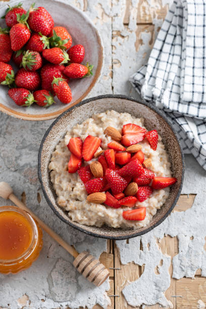 istock Breakfast oatmeal with strawberries and honey 1323841990