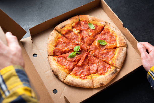 istock Pepperoni pizza in carton box 1323842098