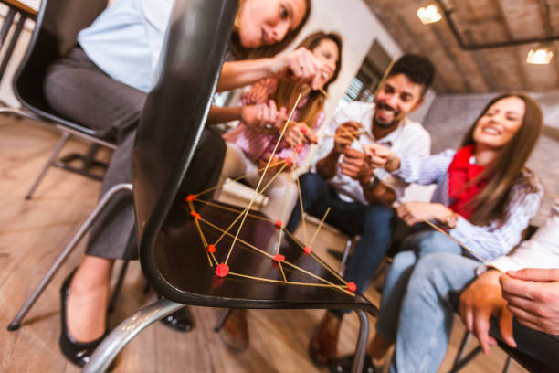 istock Business team having fun at corporate training, funny teambuilding activity 1323842186
