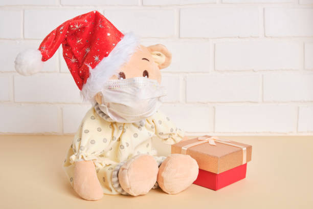 istock cute plush teddy bear in santa claus hat 1323843308