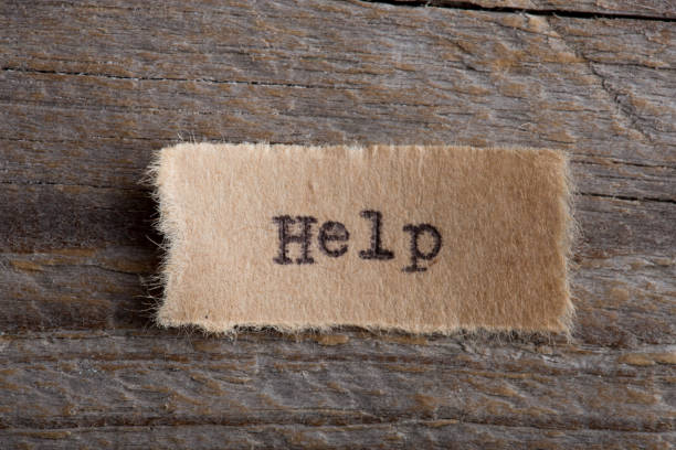 istock Help word on a piece of paper close up 1323843919