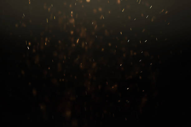 istock texture of gold dust or drops on a black background, overlay 1323844826