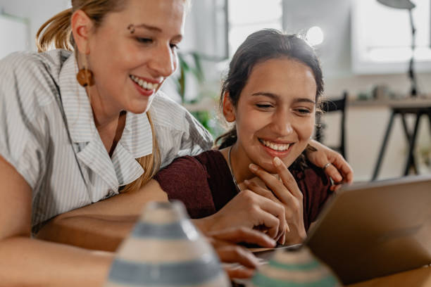 istock LGBT Lesbian couple at home is using laptop 1323846309