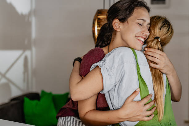 istock LGBT Lesbian couple embracing at home 1323846429