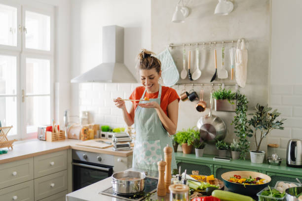 istock Young woman cooking homemade pasta 1323846490
