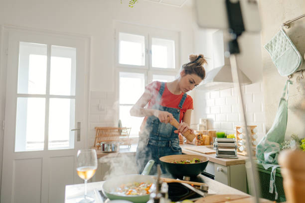 istock Young woman filming content for her cooking vlog 1323846602