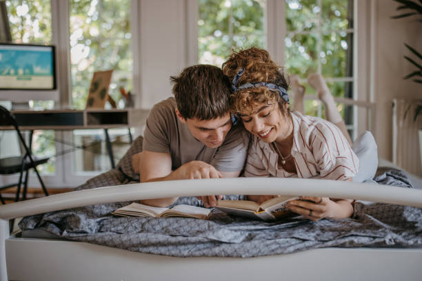 istock Couple studying together in bed 1323846709