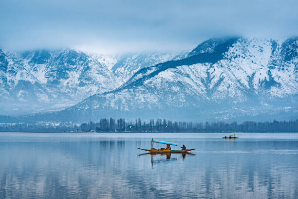 A beautiful view of Dal Lake in winter, Srinagar, Kashmir, India. A view of Dal Lake in winter, and the beautiful mountain range in the background in the city of Srinagar, Kashmir, India. jammu and kashmir photos stock pictures, royalty-free photos & images