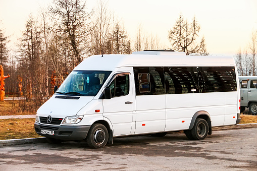 Novyy Urengoy, Russia - May 23, 2021: White compact bus Mercedes-Benz Sprinter in the city street.