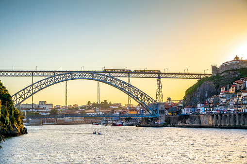 Cityscape of Porto with Douro river and famous bridge by sunset, northern Portugal