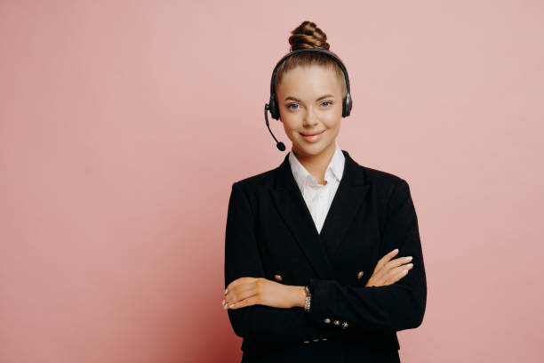 istock Happy female support center agent in dark suit posing in studio 1323849350