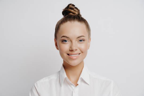 istock Smiling official female worker in white shirt 1323849355