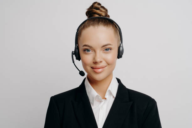 istock Female customer service representative in dark suit listening to customer 1323849379