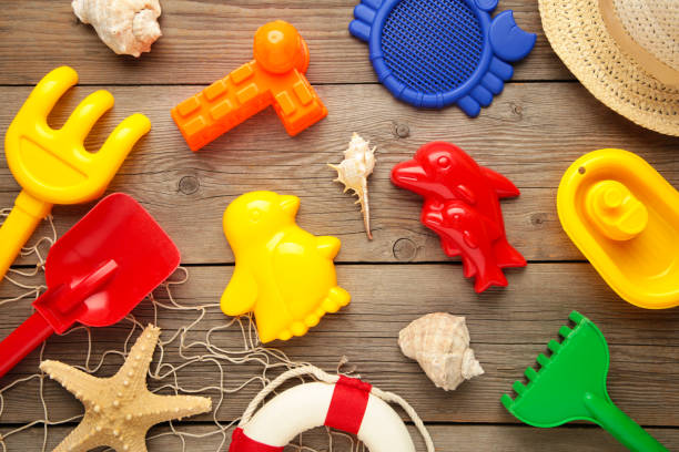 istock Summer beach toys on grey wooden background 1323850554