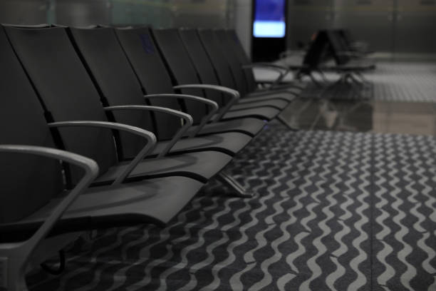 istock Waiting area with seats in airport terminal, space for text 1323850842