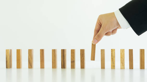 istock Businessman creating brand concept with wooden blocks on white background table. 1323852002