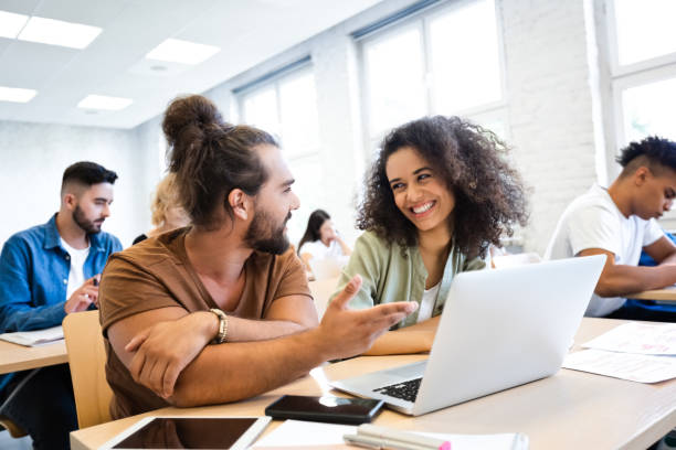 istock Male and female friends sharing ideas in classroom 1323852948