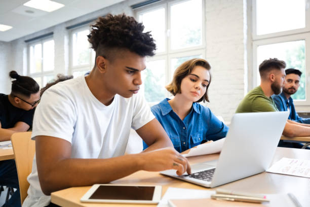 istock Man and woman are learning through laptop in class 1323853056
