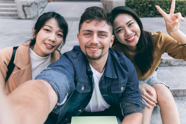 istock Asian student taking selfie in school 1323853064