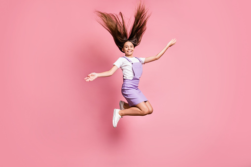 Full length body size view of her she nice attractive lovely charming carefree glad cheerful, cheery long-haired girl jumping having fun enjoying isolated over pink pastel color background