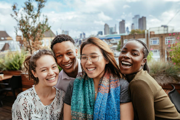 Multi ethnic young people laughing after reopening