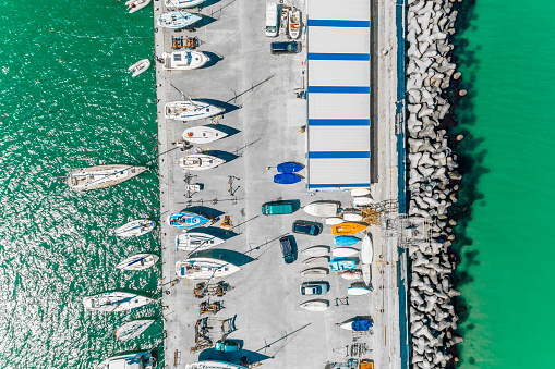 Aerial shot of Burgas pier with sailing boats on it - (Bulgarian: Пристанище Бургас, България с много лодки ). The scene is situated outdoors near noon in Burgas, Bulgaria on the Black Sea shores. The photo is taken with DJI Phantom 4 Pro drone.