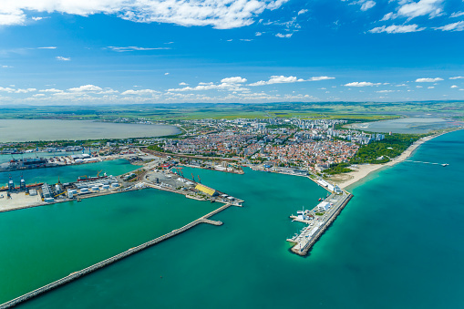 Aerial shot of  Black sea coastline and Burgas port - (Bulgarian: Брегова линия на Черно море и пристанище Бургас, България). The scene is situated outdoors near noon in Burgas, Bulgaria on the Black Sea shores. The photo is taken with DJI Phantom 4 Pro drone.