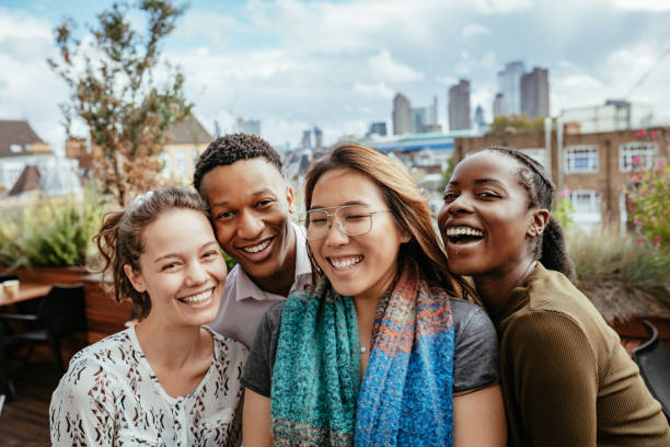 istock Group of multi ethnic millennial people smiling and looking at camera 1323853340