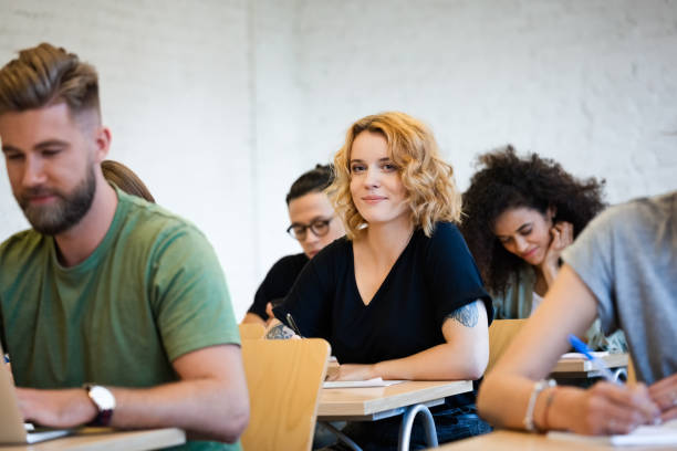istock Smiling blond woman looking away during exam 1323853414