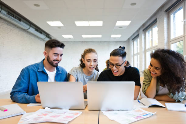 istock Students discussing over laptop in classroom 1323854348