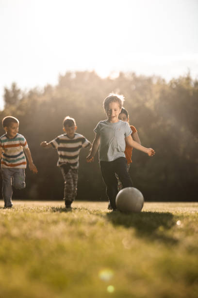 istock Children playing soccer outdoors 1323854957