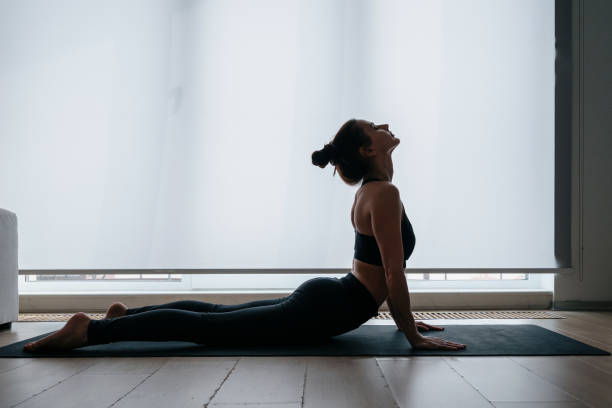 istock Woman stretching her body before workout at home 1323855125