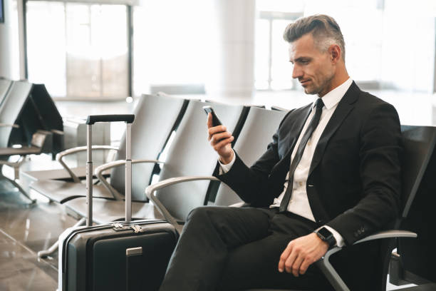 istock Handsome mature businessman using mobile phone 1323855838
