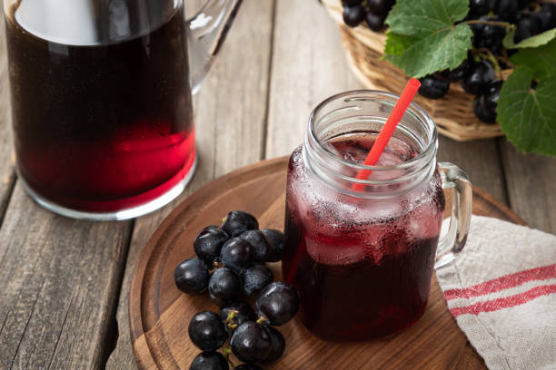 istock Glass of Grape Juice and Fresh Grapes 1323856494