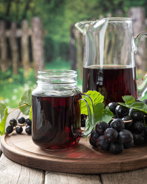 istock Glass of Grape Juice and Fresh Grapes 1323856520