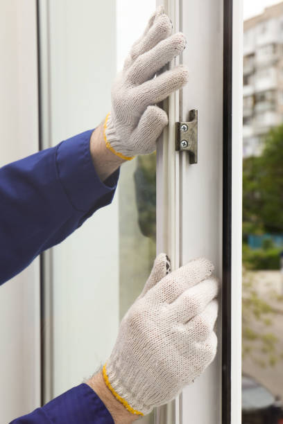 istock Worker putting rubber draught strip onto window indoors, closeup 1323856682