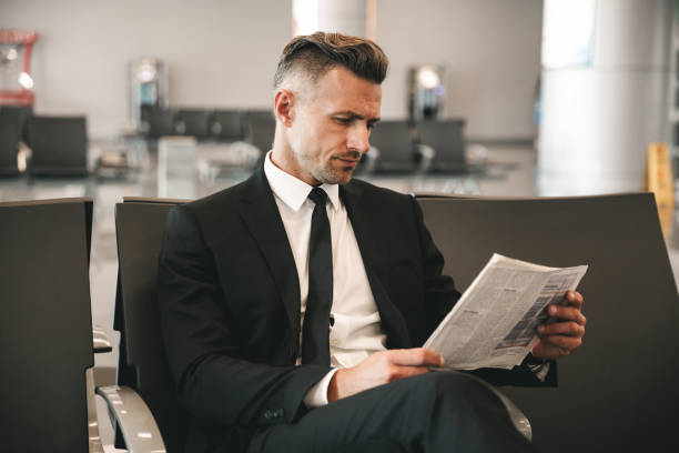 istock Successful businessman reading newspaper 1323856696
