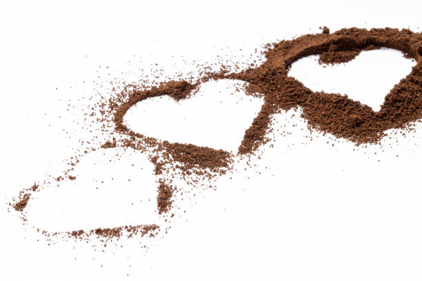 istock ground coffee powder isolated on white background. caffeine addiction concept. above view. coffee heart shapes cut out 1323857452