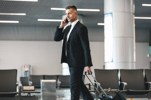 istock Attractive mature businessman talking on mobile phone 1323857598