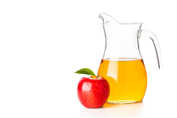 istock Crystal jar full of apple juice on white background 1323857968