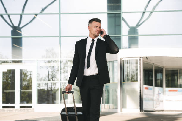 istock Handsome businessman dressed in suit walking 1323858979