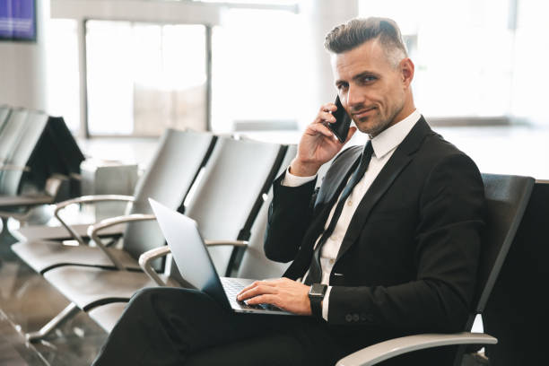 istock Smiling mature businessman talking on mobile phone 1323859382