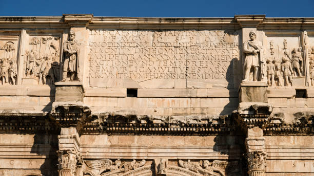 View of Arco di Costantino in sunny weather in Rome. A 21m high Roman structure made up of 3 arches decorated with figures & battle scenes