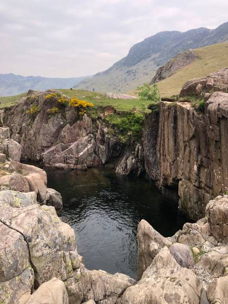 Black Moss Pot, Lake District, Cumbria, United Kingdom A view of Black Moss Pot and the Langdale valley, Lake District, Cumbria, England United Kingdom langdale pikes stock pictures, royalty-free photos & images