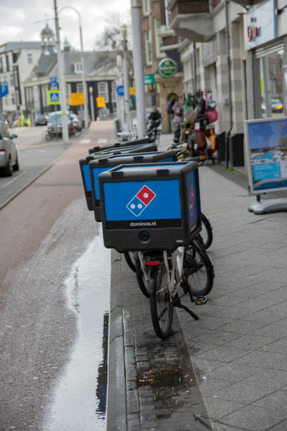 dominos pizza delivery bicycles w amsterdamie holandia - dominos pizza zdjęcia i obrazy z banku zdjęć