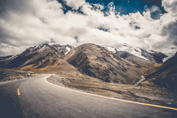 istock Motion Shot Of Beautiful Road Between Huge Mountains Best View 1323865757