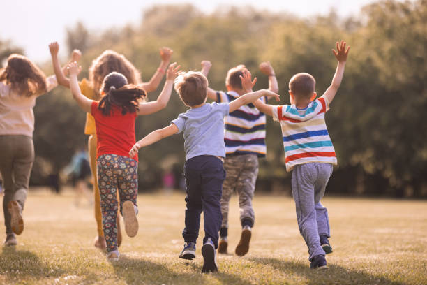 istock Kids having fun running outdoors 1323865984