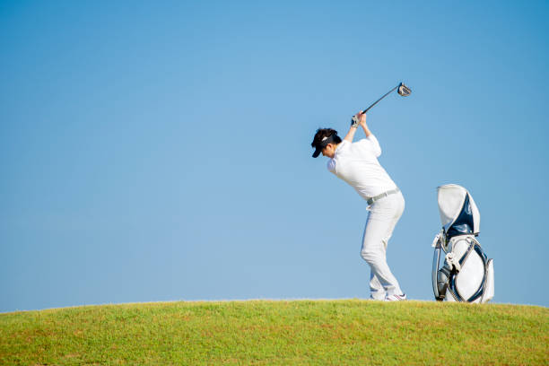 istock golfer standing  on slope  with golf bag hitting  golf ball 1323866289
