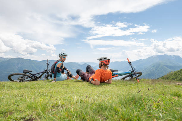 istock Mountain bikers contemplate the lake and mountain view 1323866315