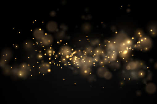 Light abstract glowing bokeh lights. Shining star, sun particles and sparks with lens flare effect on black background. Sparkling magical dust particles. Christmas concept.